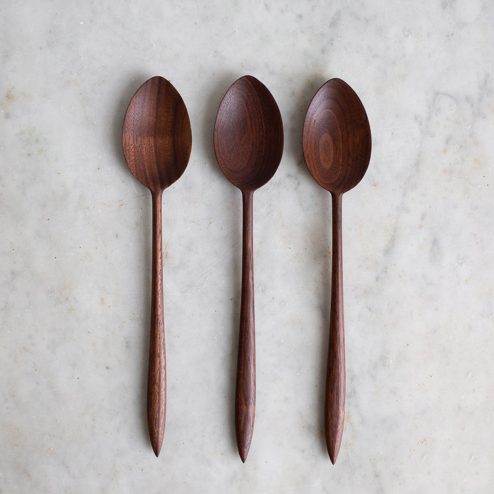 https://www.elleihome.com/cdn/shop/products/INGREDIENTS_LDN_hand_carved_wooden_black_walnut_cooking_spoon-2_1000x1000.jpg?v=1628692280