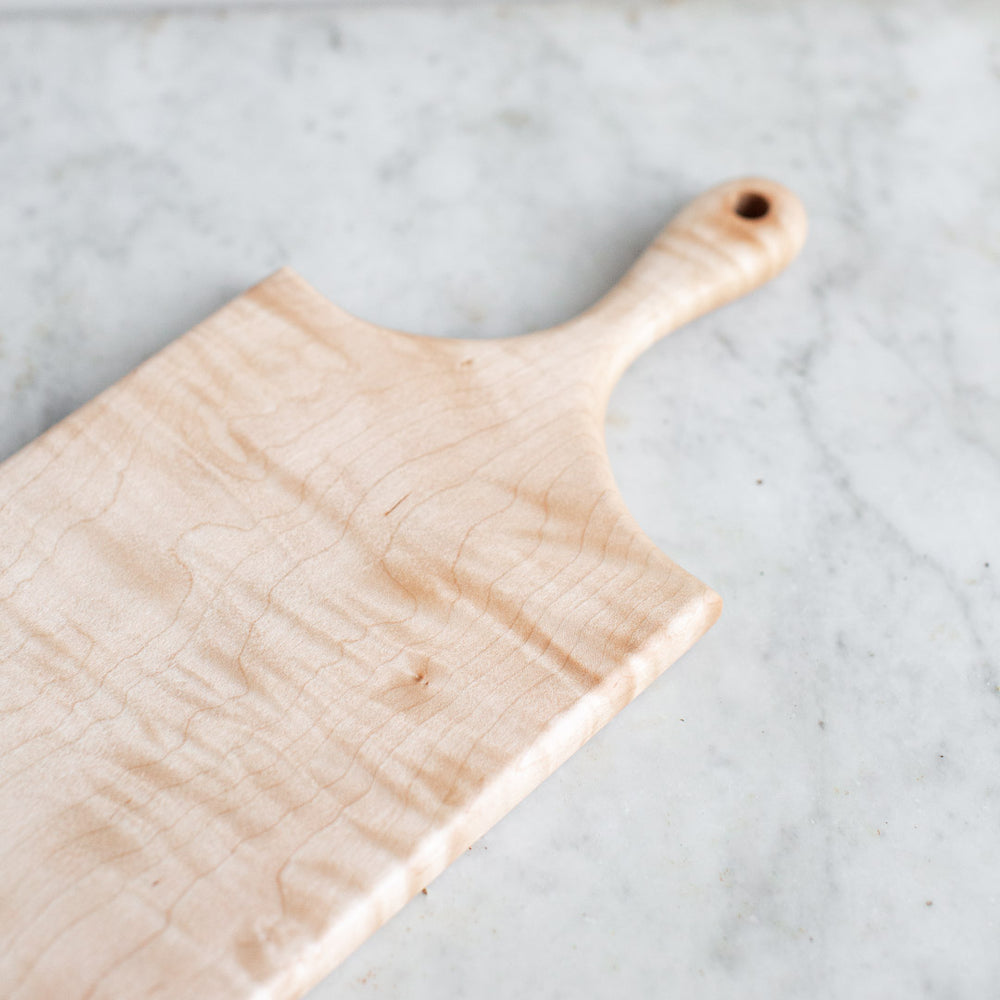 https://www.elleihome.com/cdn/shop/products/INGREDIENTS_LDN_hand_carved_wooden_curly_maple_cutting_serving_board-8_1000x1000.jpg?v=1628694667